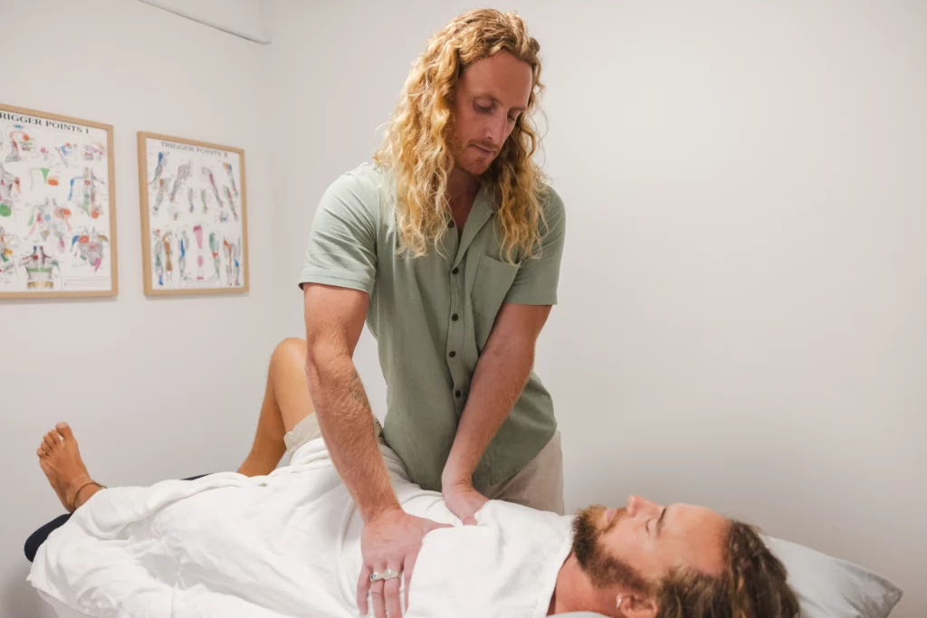 Myotherapist Riley performing myofascial release technique on patient's chest at Nature Of Wellness Gold Coast